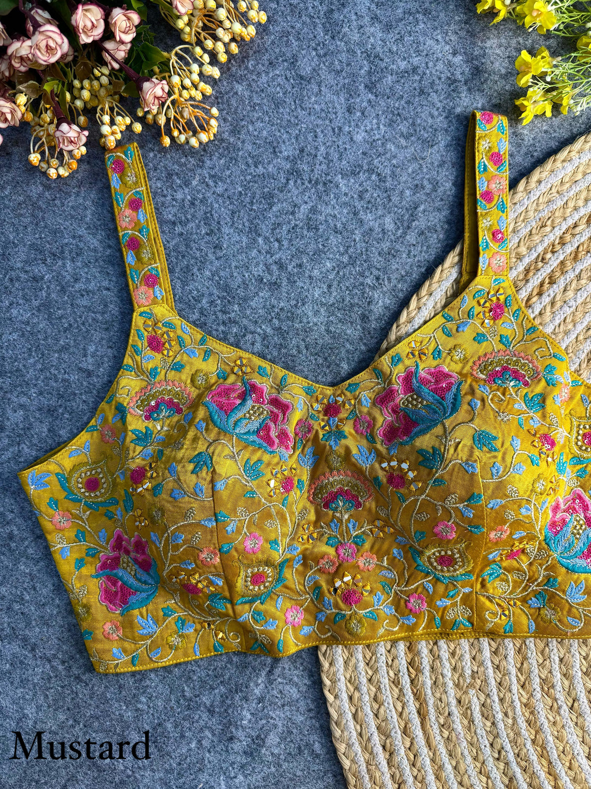 Elegant mustard yellow silk blouse adorned with intricate embroidery and shimmering sequin work, perfect for festive and traditional wear