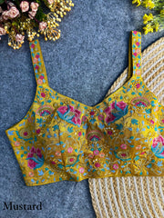 Elegant mustard yellow silk blouse adorned with intricate embroidery and shimmering sequin work, perfect for festive and traditional wear