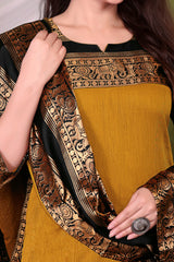 Woman wearing a mustard yellow saree with intricate brown patterns