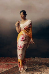 Woman wearing a floral saree with a dark background