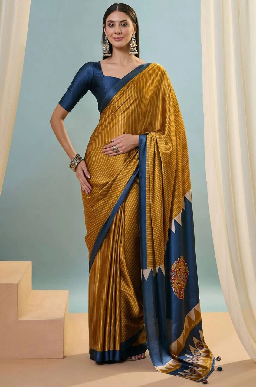 Woman wearing a mustard yellow saree with blue border against a light blue background