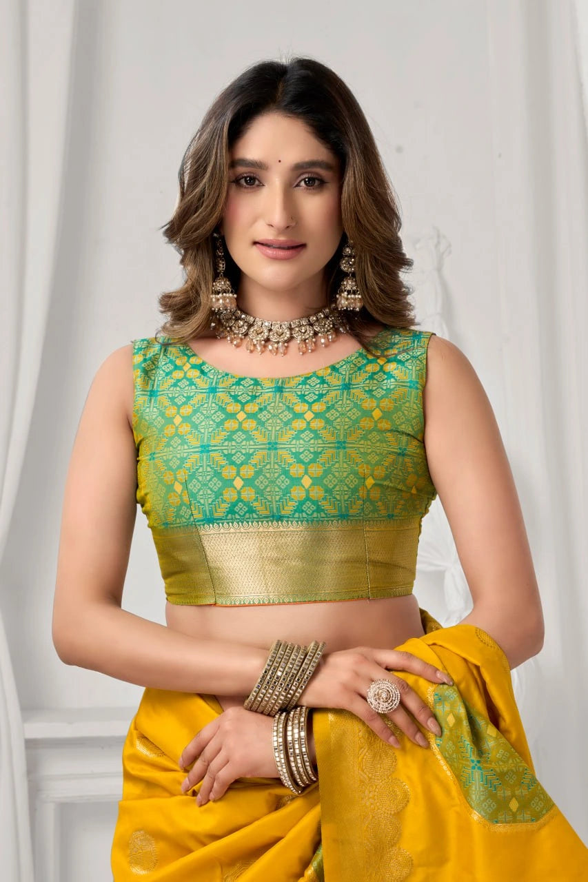 Woman wearing a green and yellow traditional outfit with jewelry against a white background