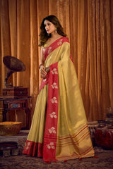 Woman wearing a yellow and red saree with a vintage background