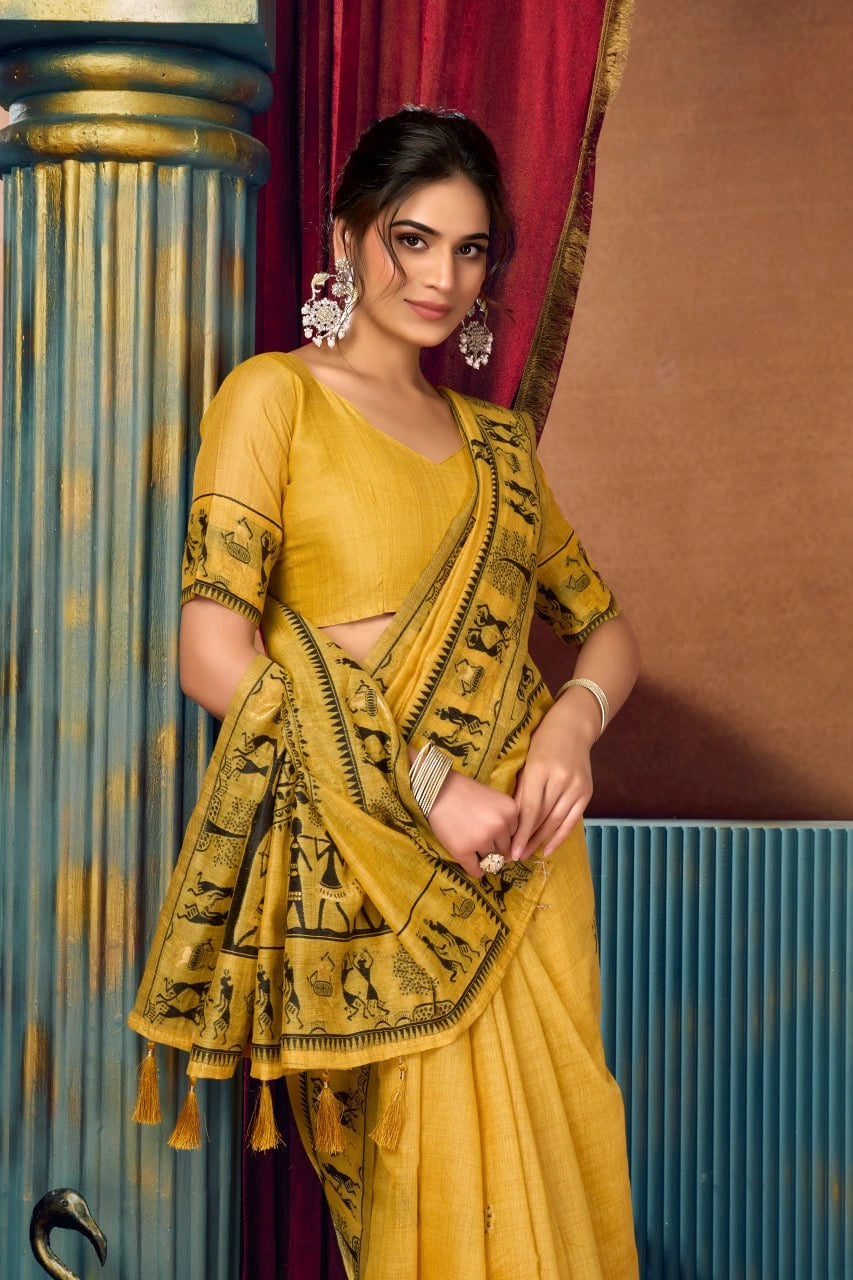Woman in a yellow saree with a red curtain and blue wall in the background
