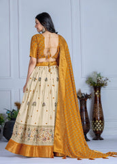 Woman wearing a traditional outfit with a yellow blouse and cream skirt in a minimalistic setting.