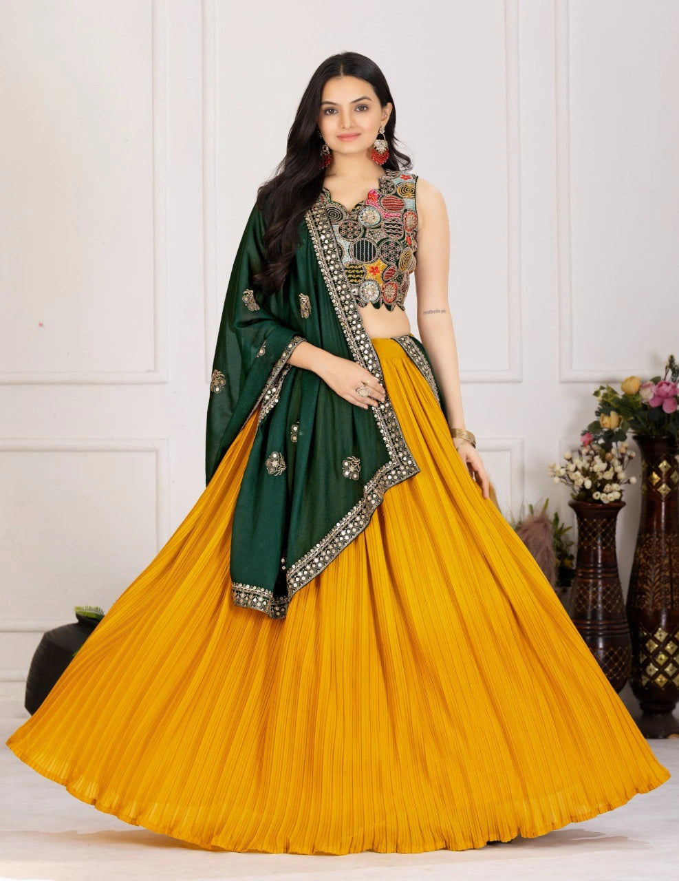 Woman wearing a green and yellow traditional outfit with floral decorations.