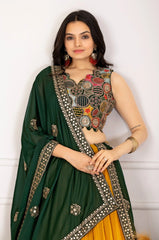 Woman wearing a green and yellow traditional outfit with intricate designs.