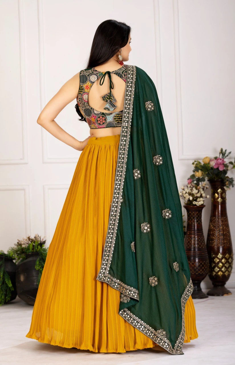 Woman wearing a yellow and green traditional outfit with a floral blouse and green dupatta.
