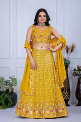 Woman in a yellow embroidered traditional outfit with a white background