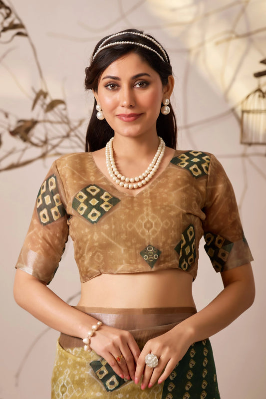 Woman wearing a traditional outfit with intricate designs and jewelry against a neutral background