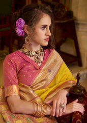 Woman in a traditional saree with jewelry and a purple flower in her hair.