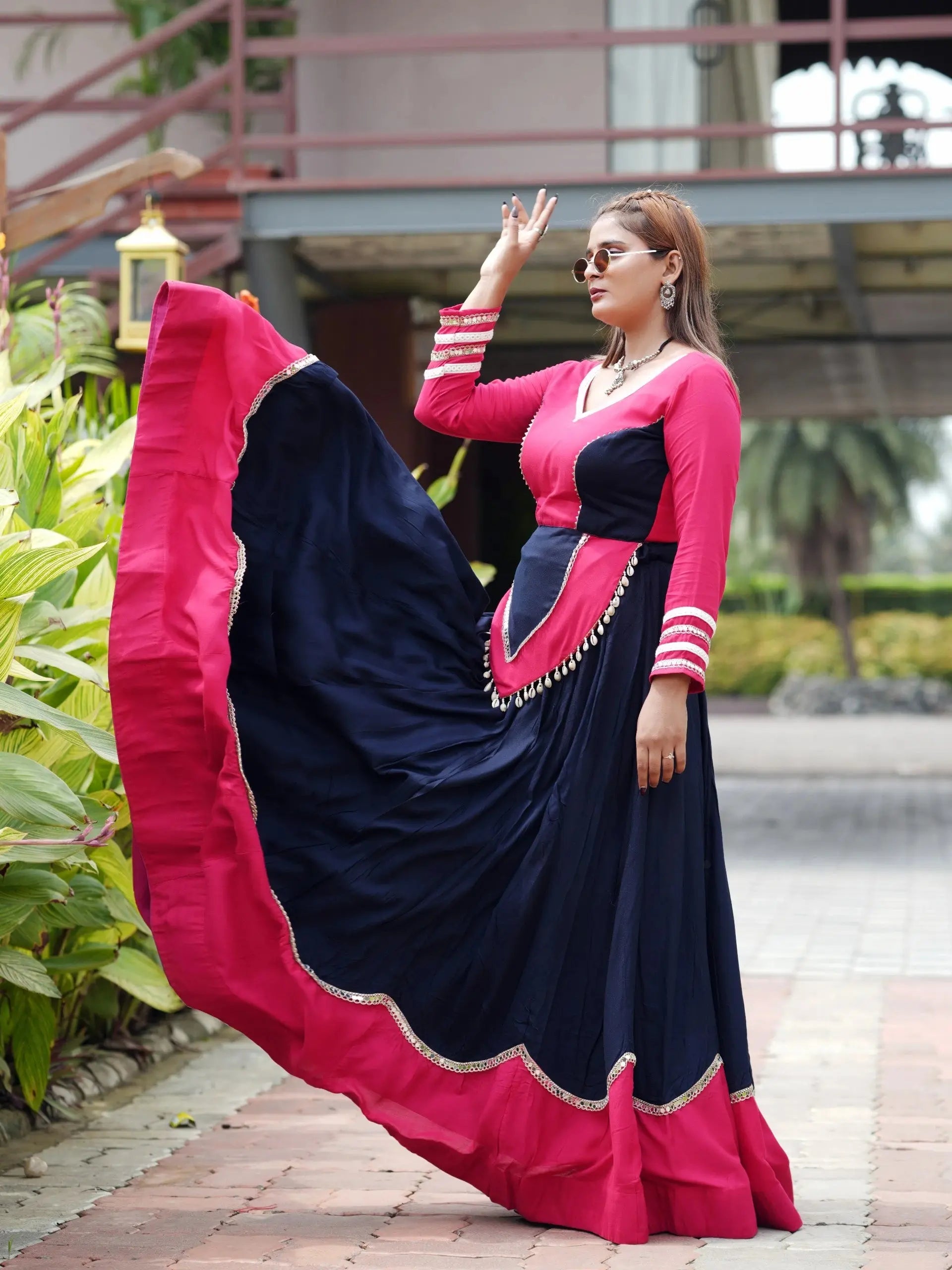 Side view of navy blue mirror lace work lehenga showing full 6-meter circular flair with pink border