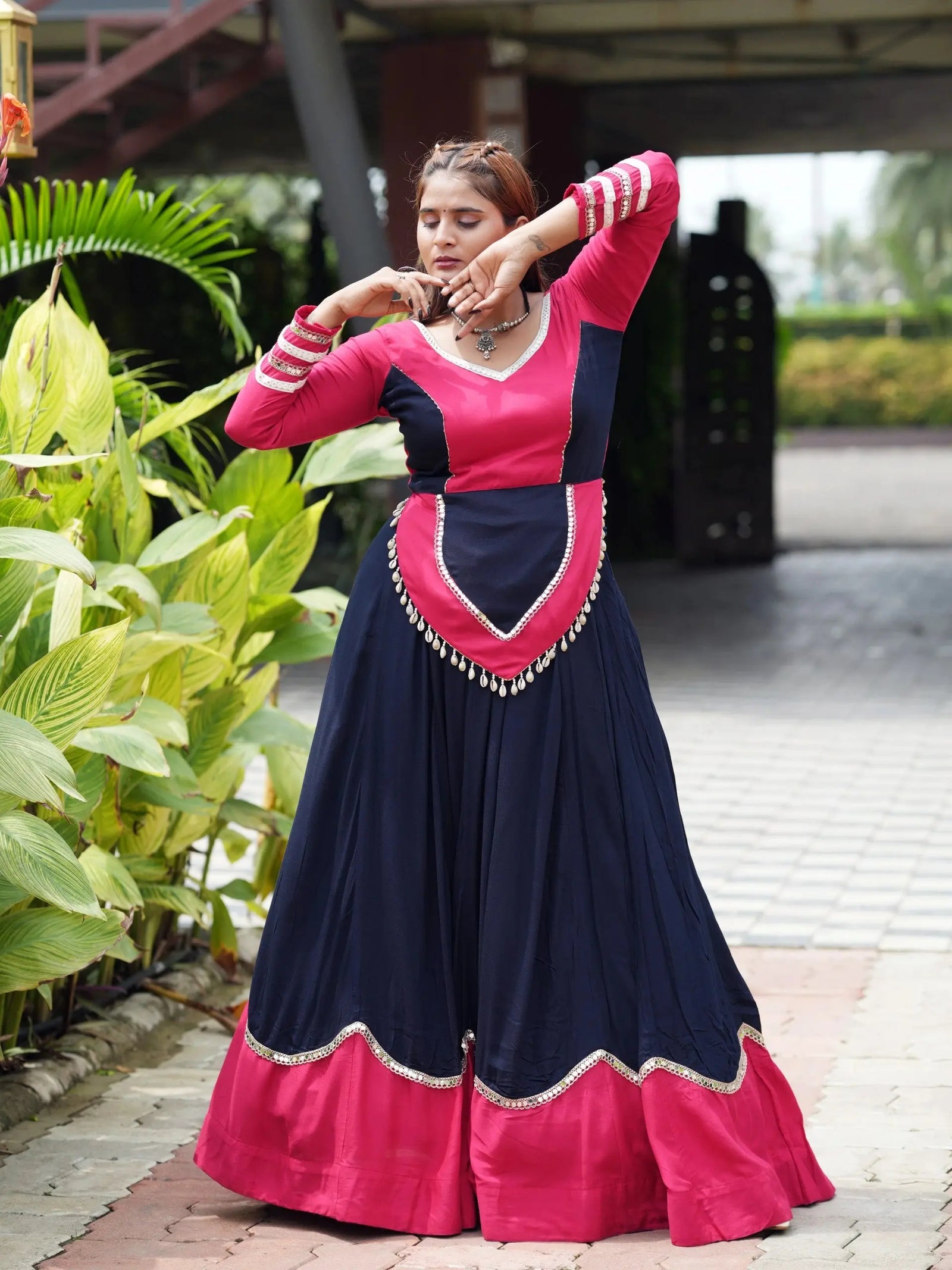 Navy Blue Mirror Lace Work Lehenga with cowrie shell peplum and pink choli, dancing front view