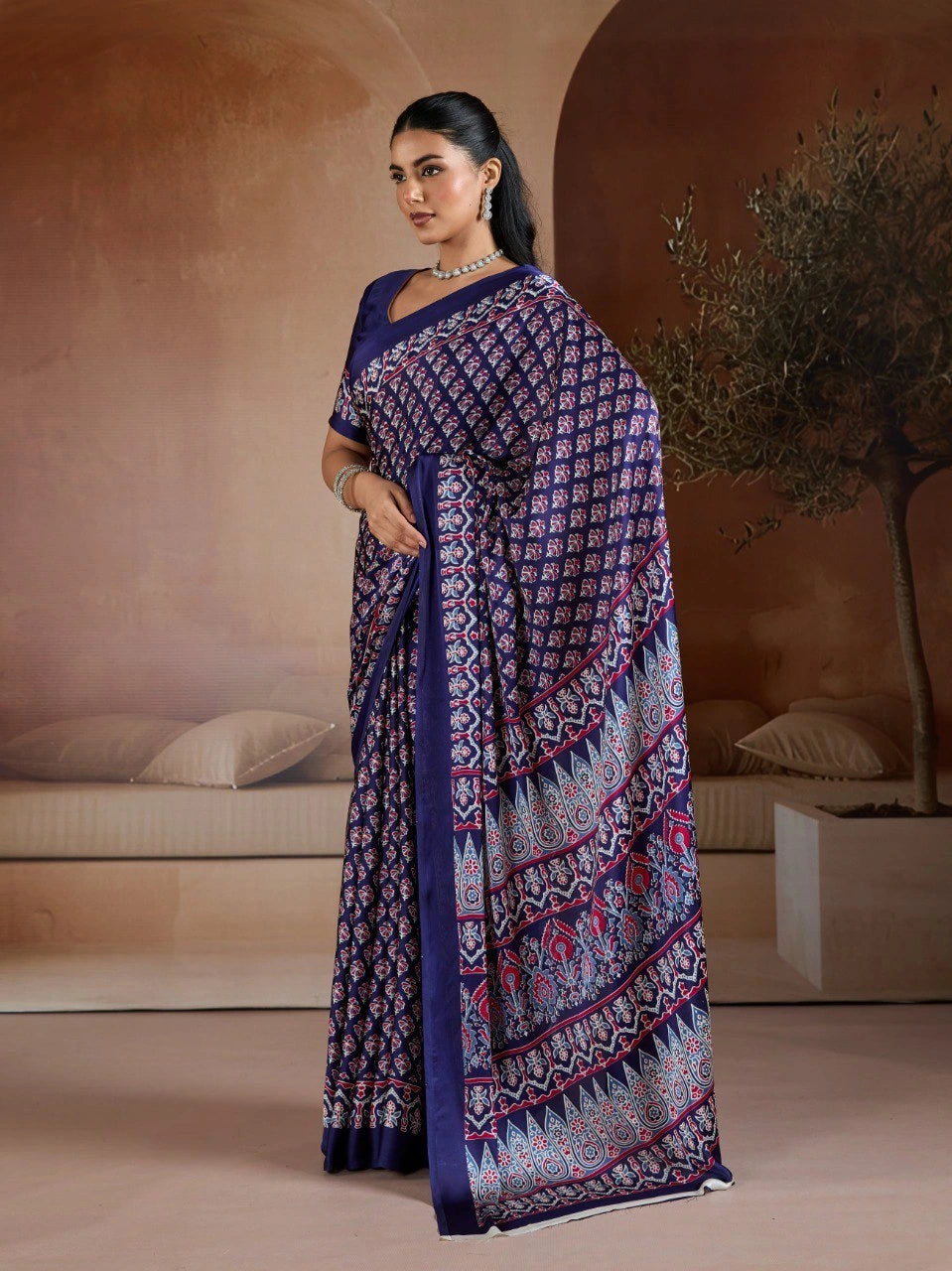 Woman wearing a patterned saree in an indoor setting