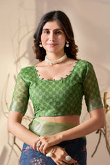 Woman wearing a green patterned blouse with a neutral background