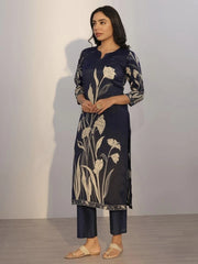 Woman wearing a navy blue kurta with floral patterns against a plain background