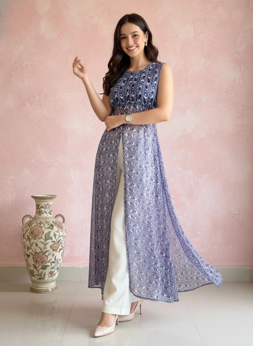 Woman wearing a sleeveless top and long skirt with a floral vase on a pink background