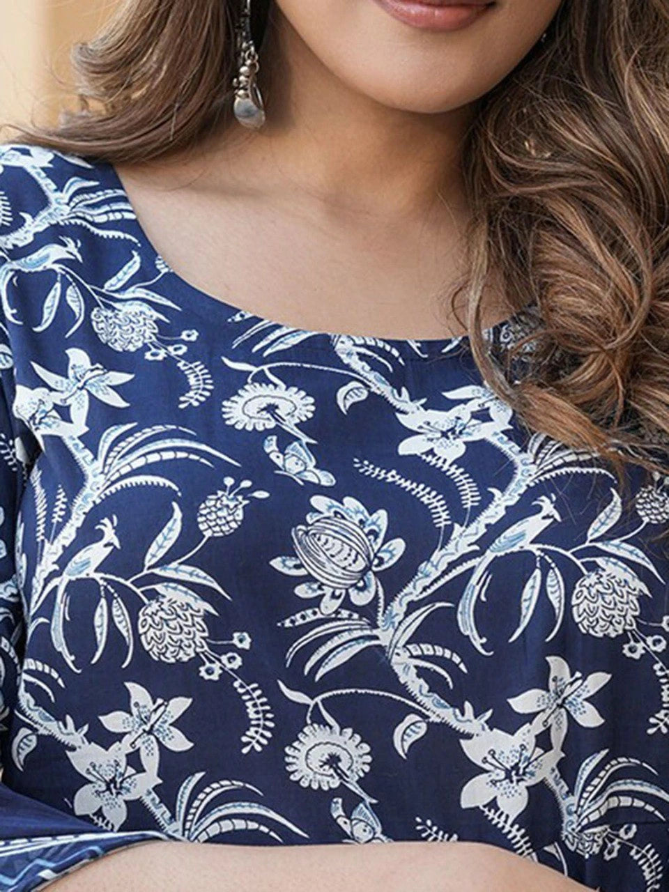 Navy blue top with white floral and peacock pattern