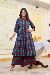Woman wearing a blue and red patterned dress in an elegant indoor setting.