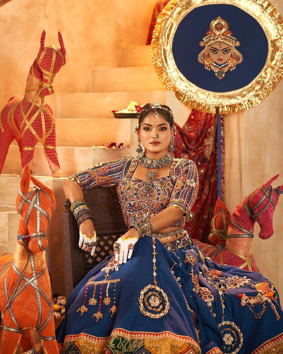 Woman in traditional attire with decorative elements and horses in the background