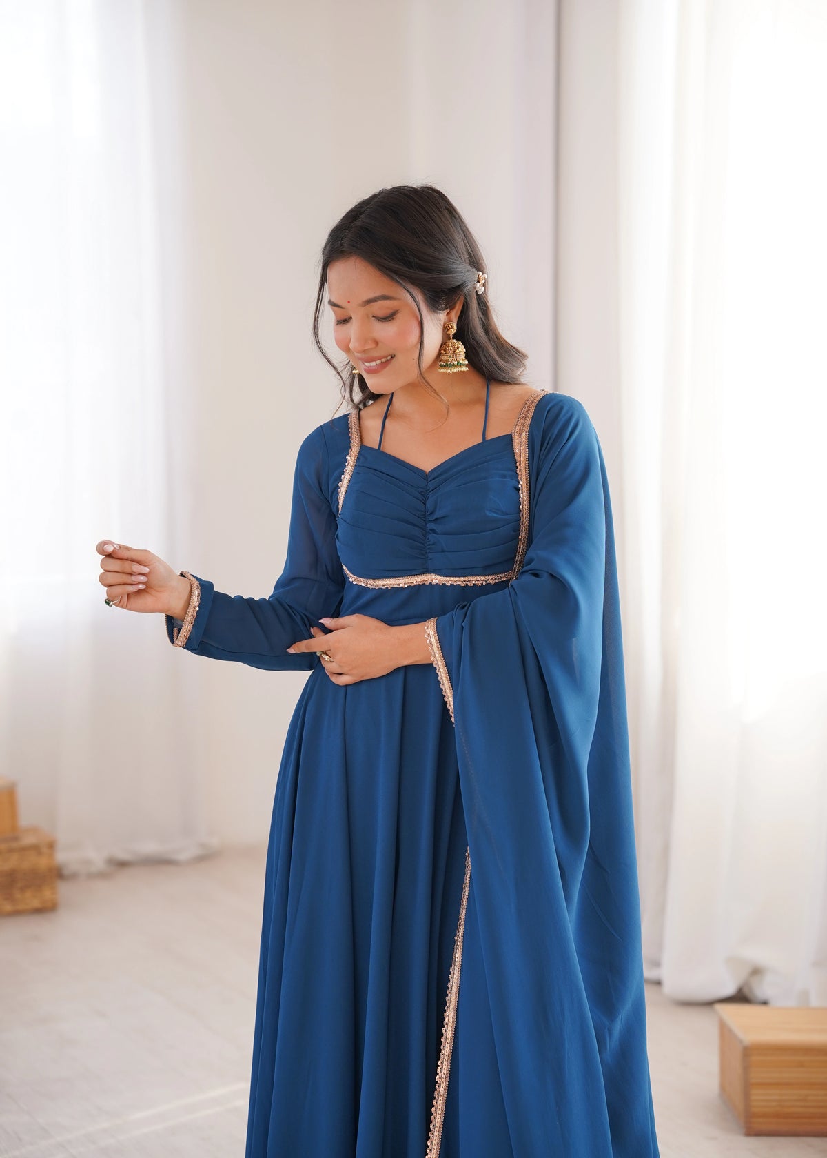 Woman wearing a blue dress with a white background