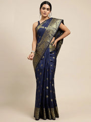 Woman wearing a navy blue saree with gold patterns on a beige background