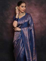Woman wearing a blue saree with a dark background