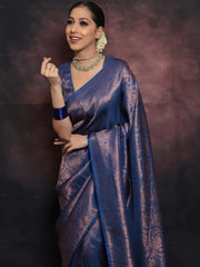 Woman wearing a blue saree with a dark background
