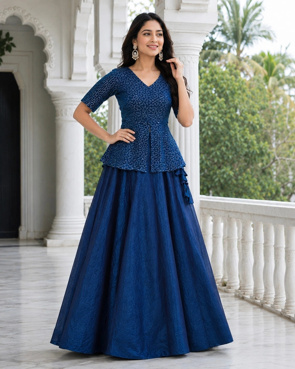 Woman wearing a blue traditional outfit standing outdoors.