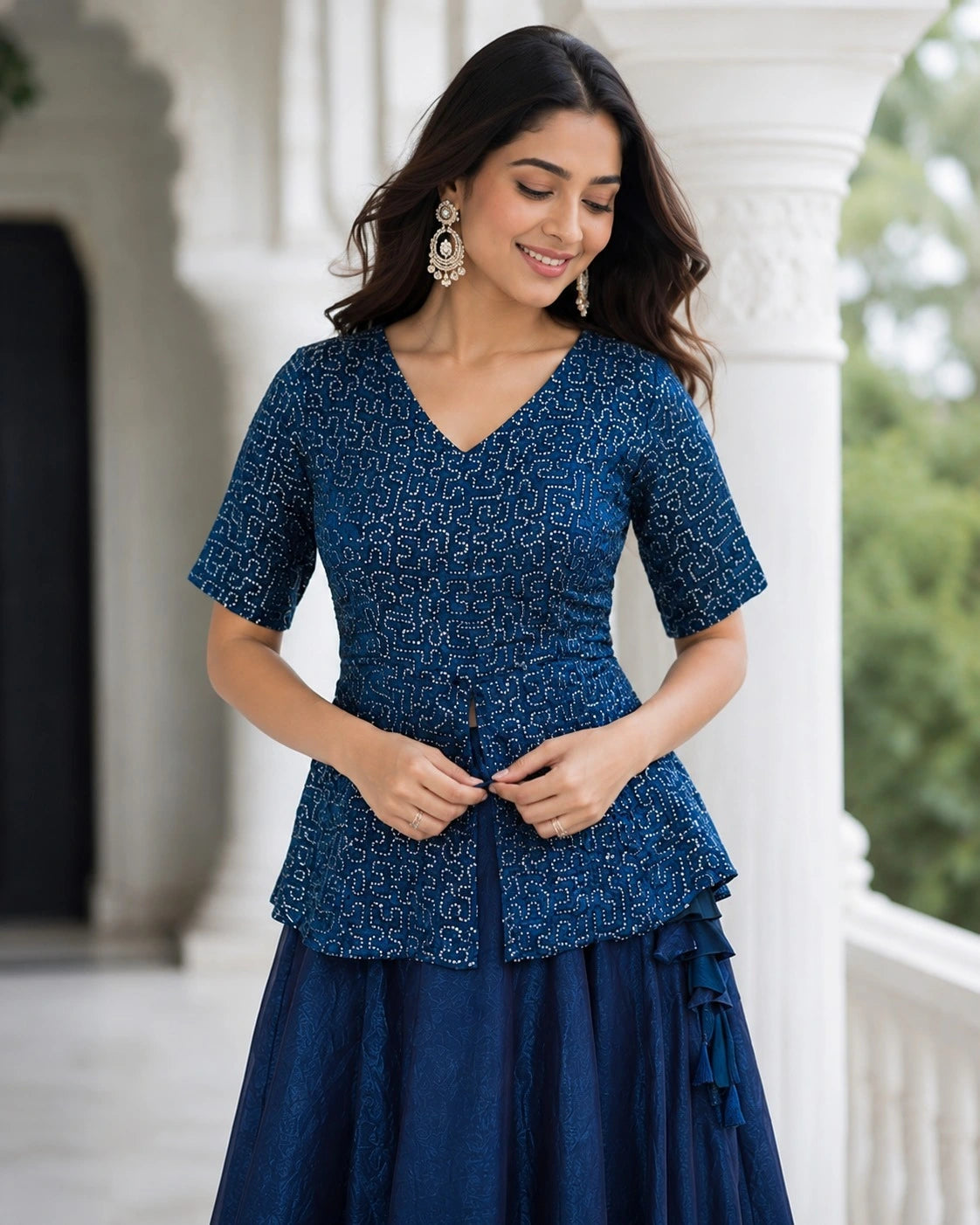 Woman wearing a blue patterned dress standing outdoors.