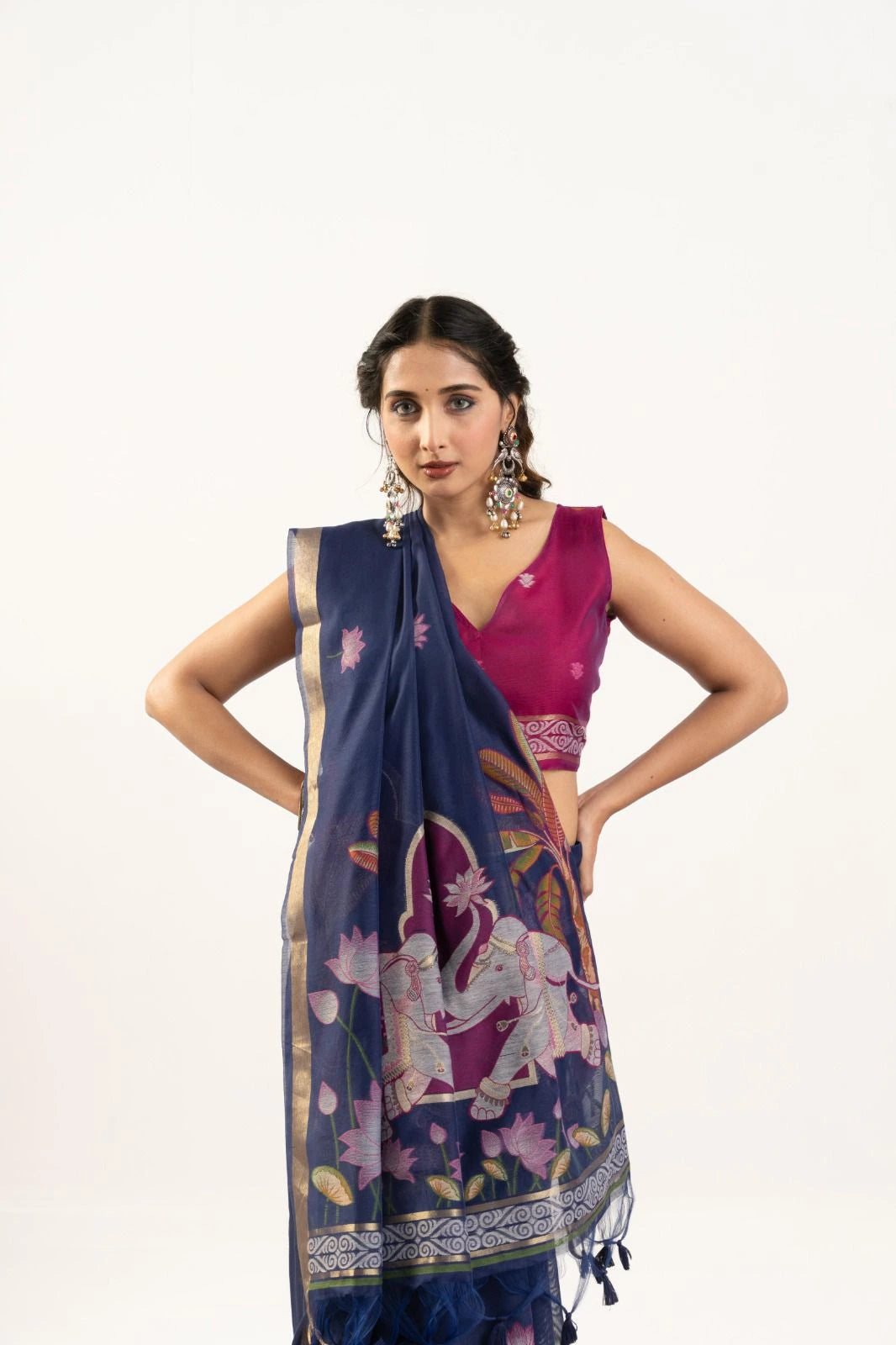 Woman wearing a navy blue saree with a white elephant design on a white background