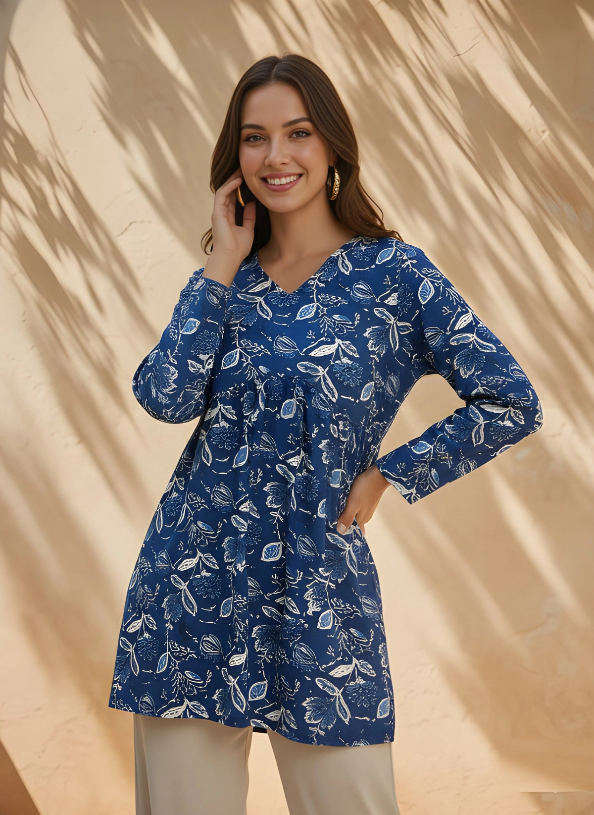 Woman wearing a blue floral dress against a beige background