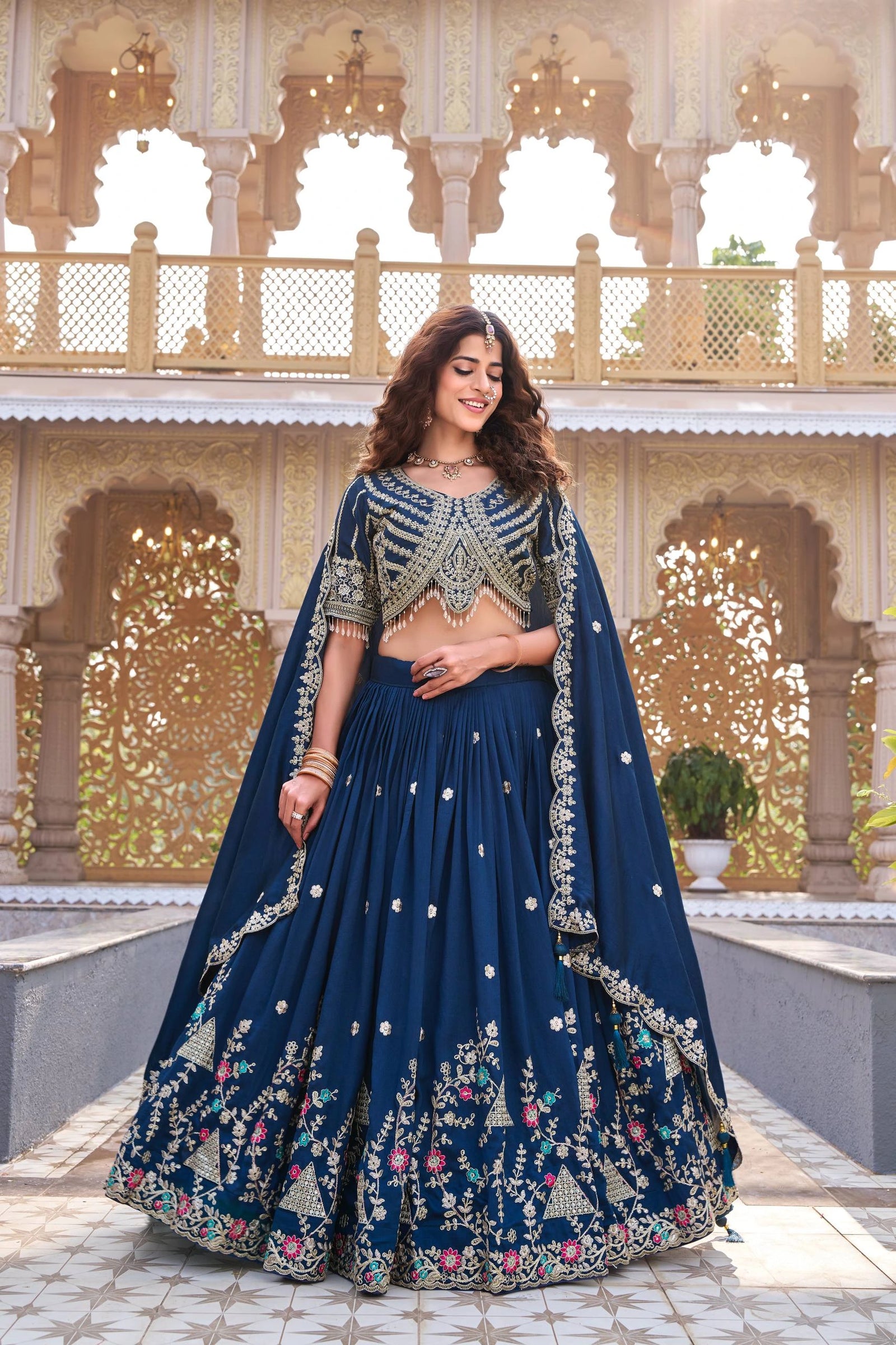 Elevate your festive wardrobe with this Navy Blue Pure Vichitra Silk Lehenga, adorned with intricate sequins and thread embroidery. Crafted from premium Vichitra silk, it offers a luxurious drape and timeless elegance, perfect for weddings, receptions, and festive celebrations.