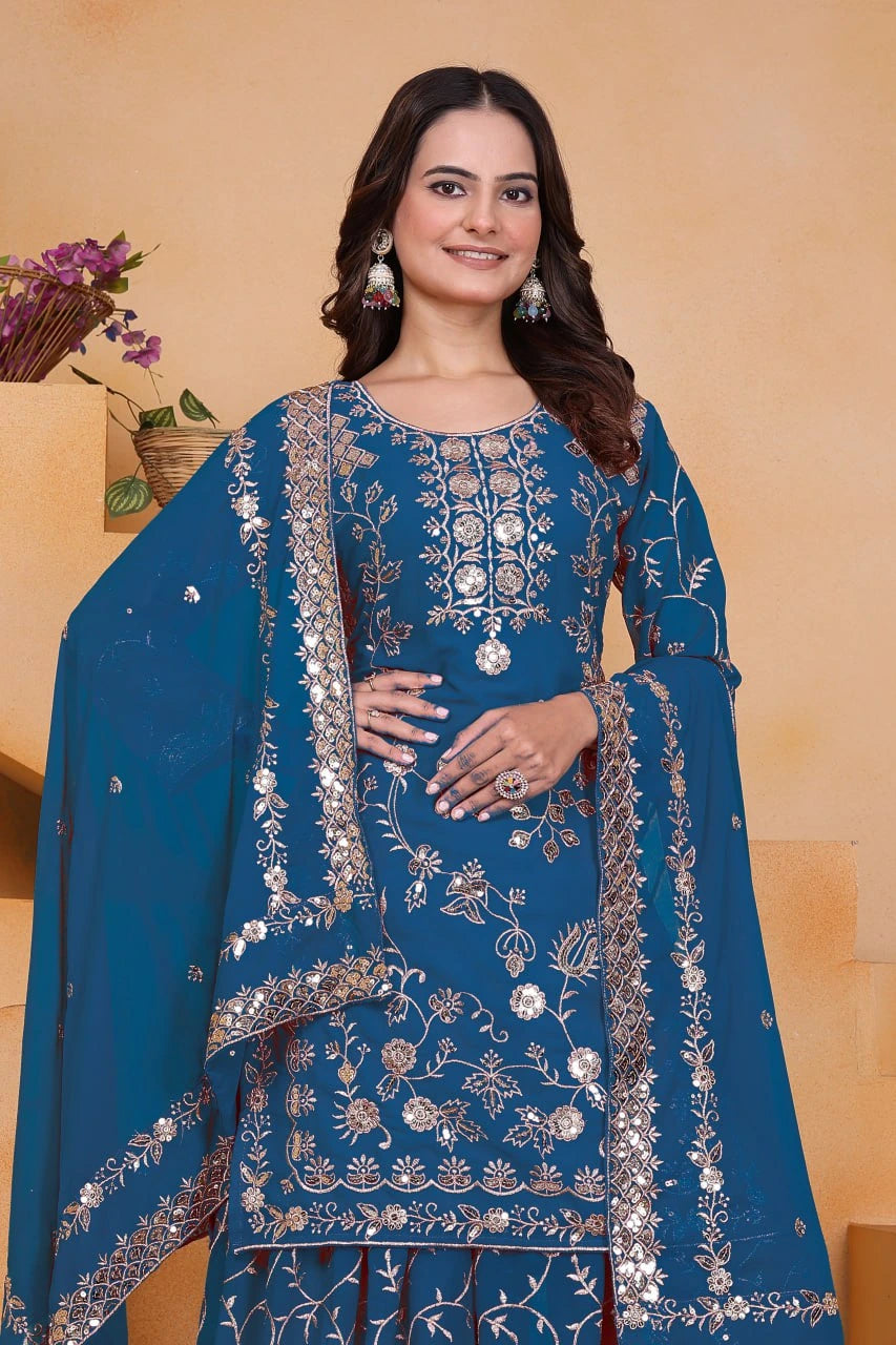 Woman wearing a blue embroidered traditional outfit with a beige background