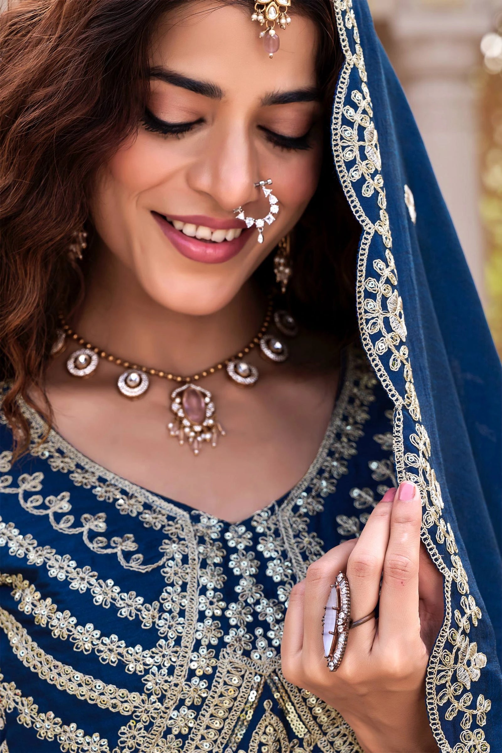 Traditional Indian bridal lehenga in navy blue with shimmering sequins showcased online