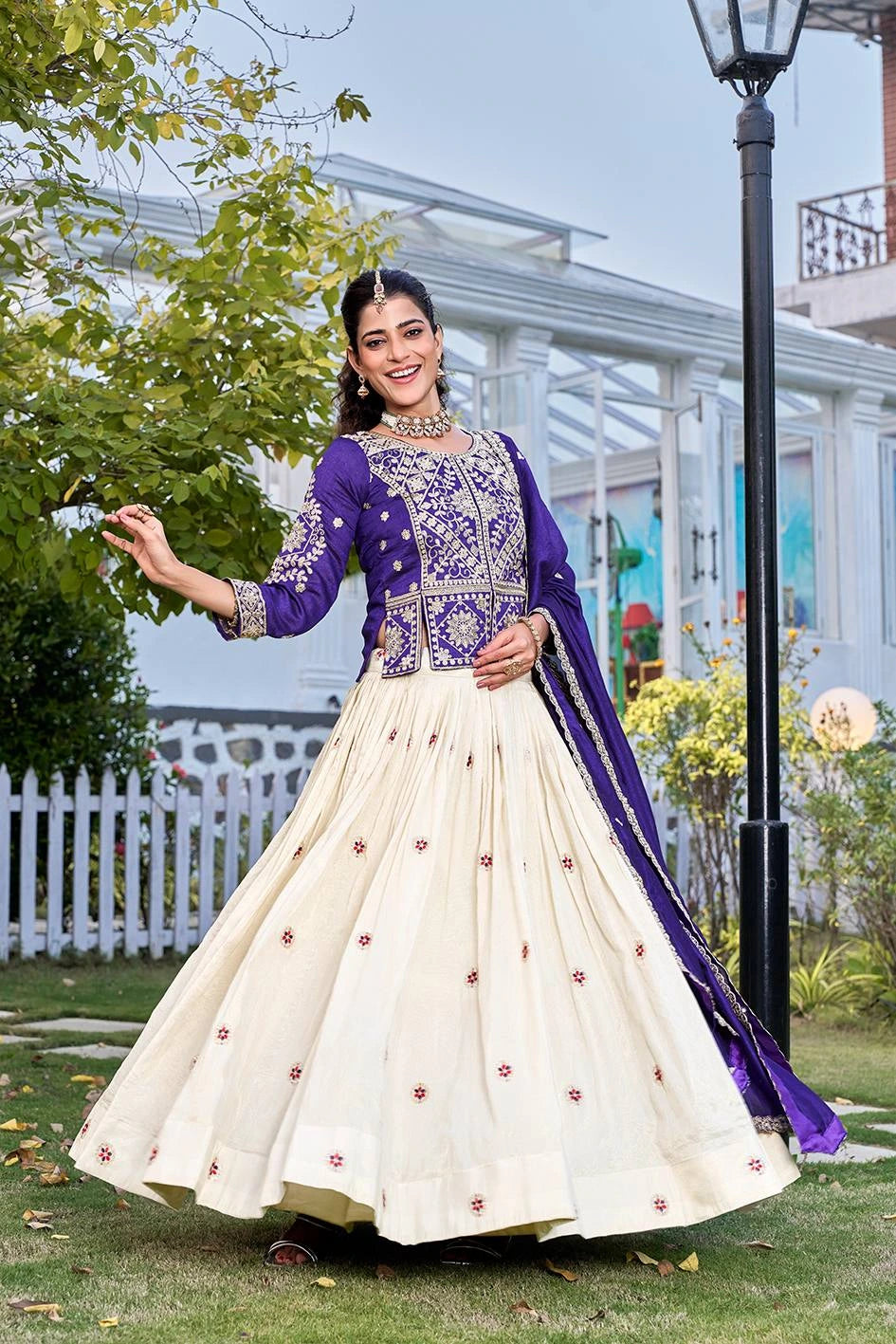 Woman in a traditional outfit with Navy Blue and white colors standing outdoors.