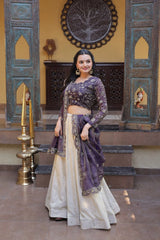 Woman in traditional outfit standing in a decorated room with wooden panels and decorative elements.