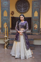 Woman in a traditional outfit standing in an ornate room with decorative walls and furniture.