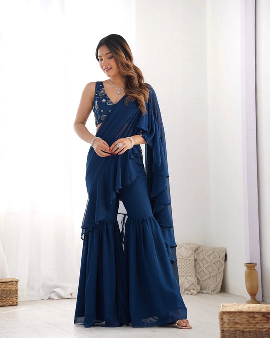 Woman wearing a blue saree with a white background