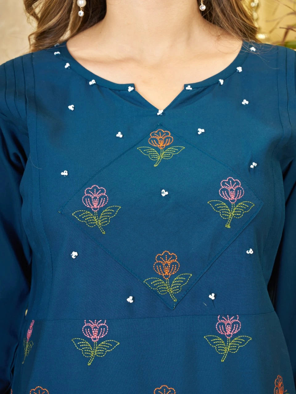 Blue dress with floral embroidery and pearl details