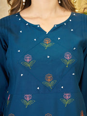 Blue dress with floral embroidery and pearl details