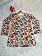 Floral dress with long sleeves on a hanger against a textured gray background