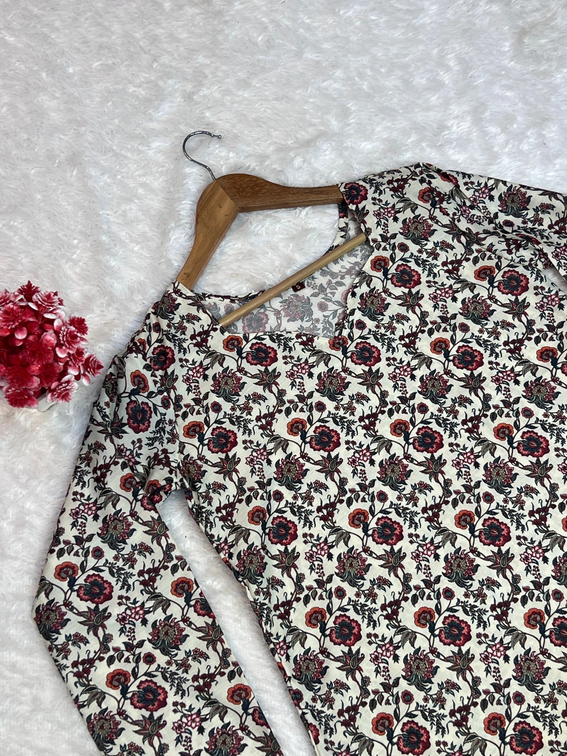 Floral-patterned fabric on a hanger with a textured white background