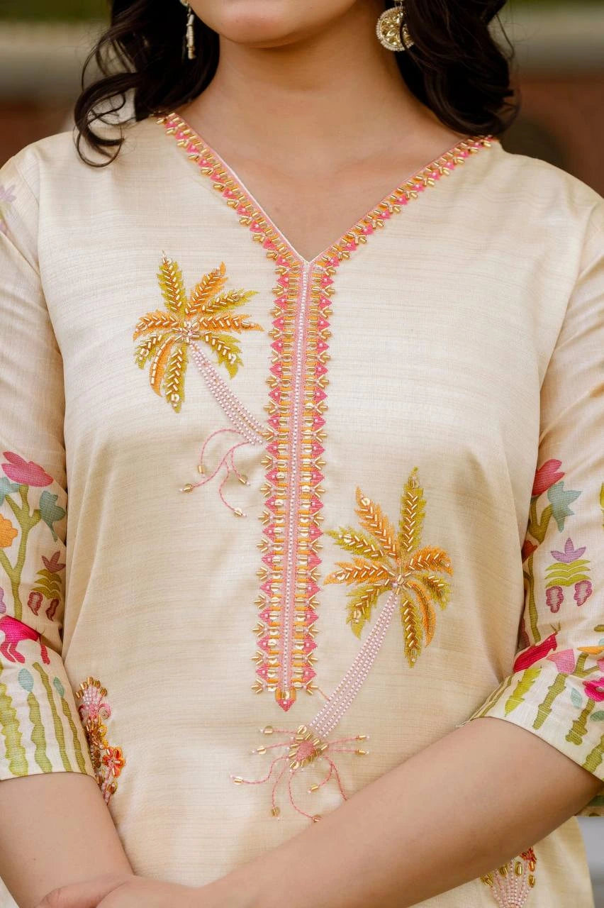 Beige embroidered top with floral patterns on a blurred background