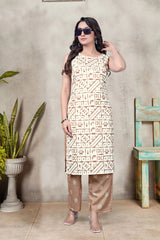 Woman wearing a patterned kurta with sheer pants against a neutral background