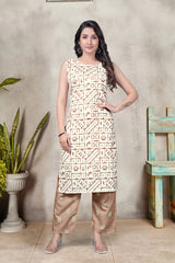 Woman wearing a patterned outfit standing against a textured wall with a plant and wooden chair.