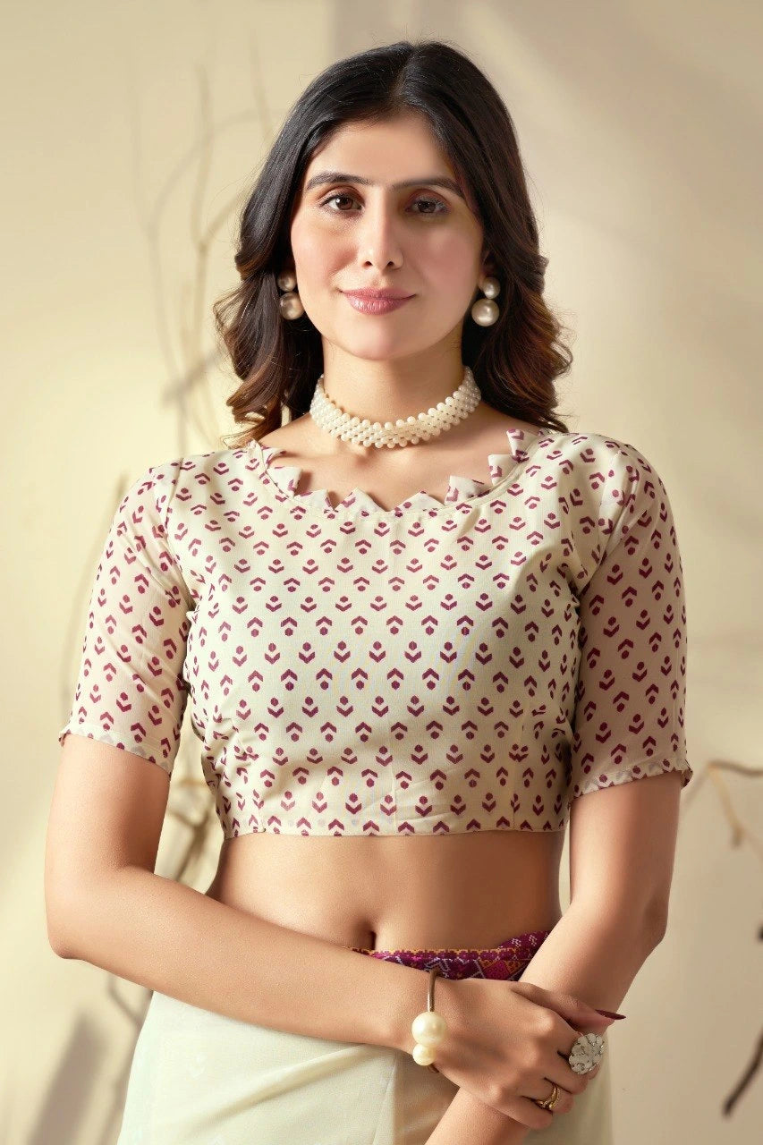Woman wearing a patterned blouse with a plain background