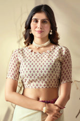 Woman wearing a patterned blouse with a plain background