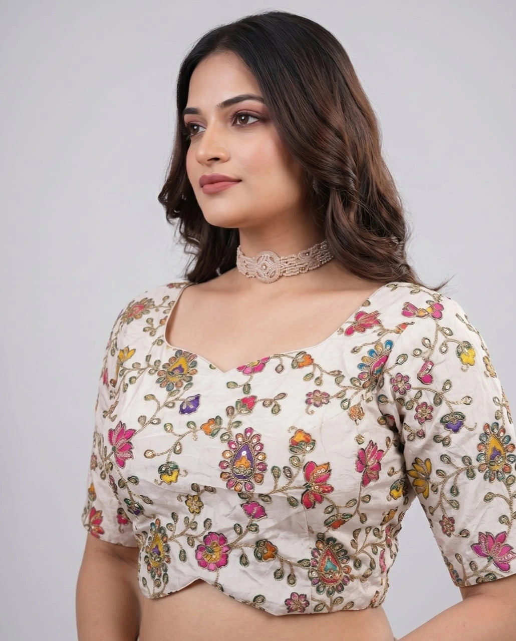 Woman wearing a floral blouse with a plain background