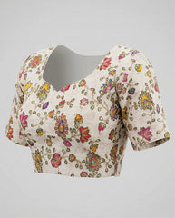 Floral embroidered blouse on a gray background